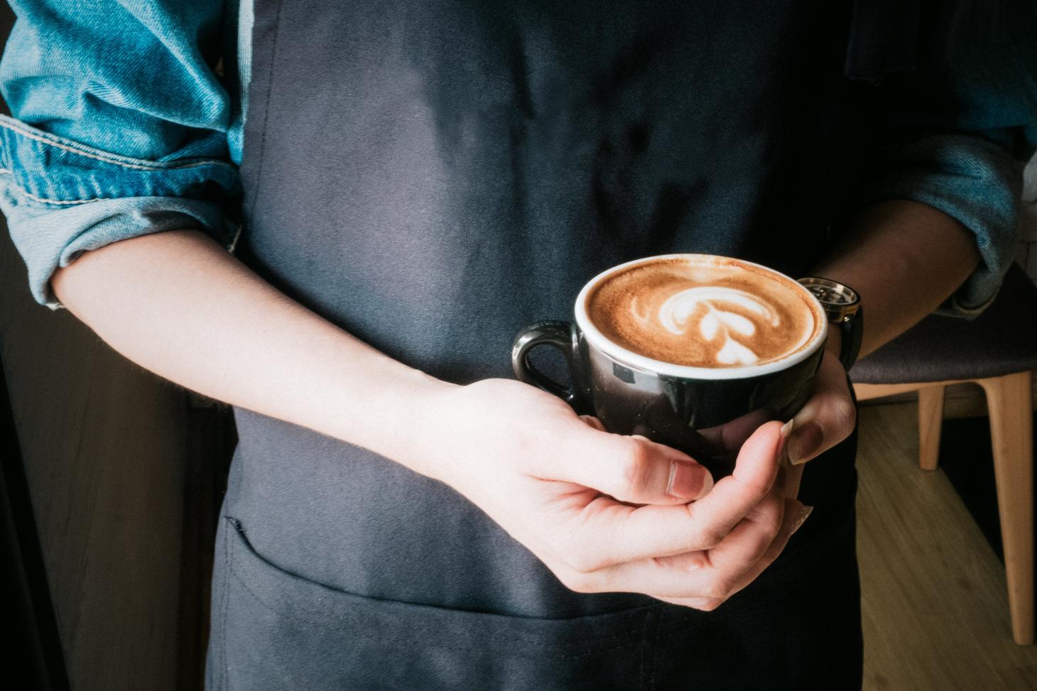 barista holding a coffee