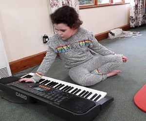 Chloe: young girl playing a keyboard