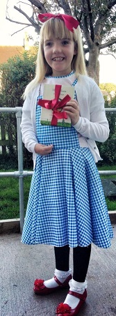 Daisy: young girl smiles and holding present