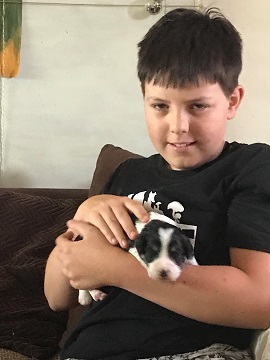Isaac holding a puppy