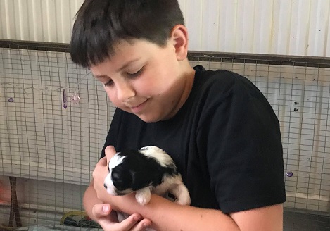 Isaac holding a puppy