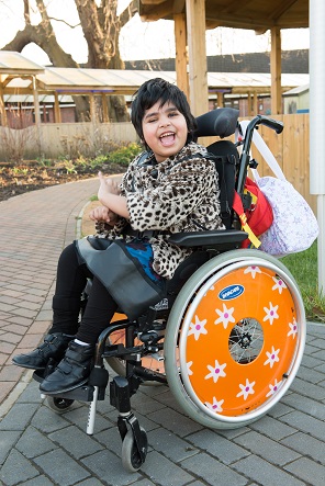 Labeebah: young girl smiling in her wheelchair