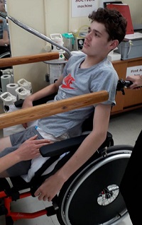 Sam: young man in wheelchair receiving rehabilitation