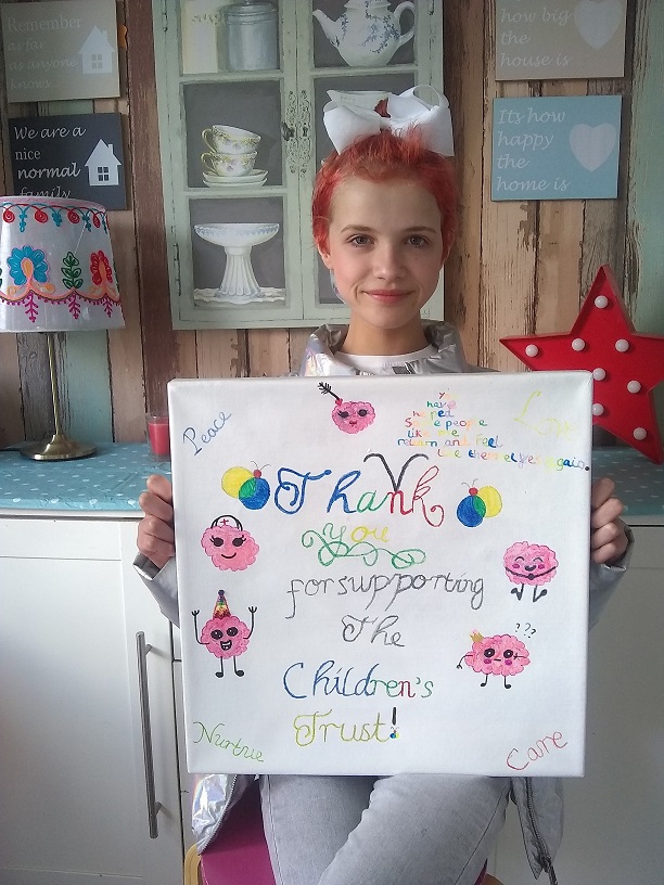 Mia holding her thank you picture