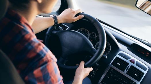 A young person driving a car