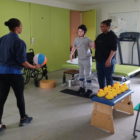 Riley being thrown a ball in a physiotherapy session
