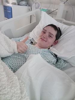 Spike giving a thumbs up in hospital