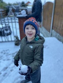 Ezra smiling outside in the snow