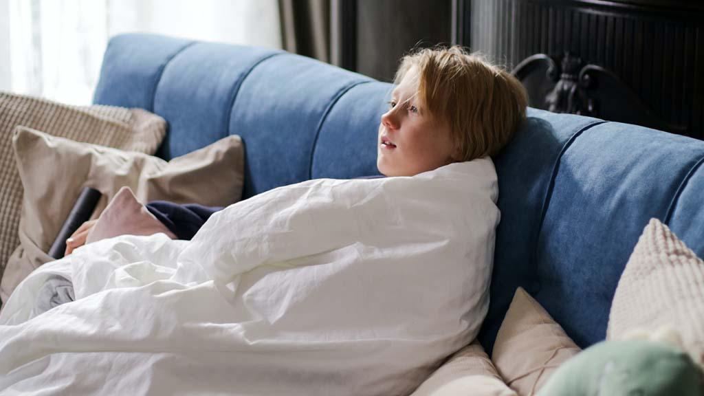 child resting on sofa