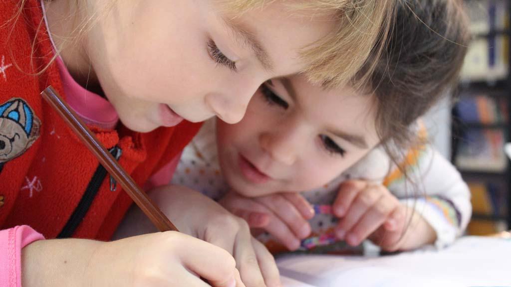 two young children studying at school