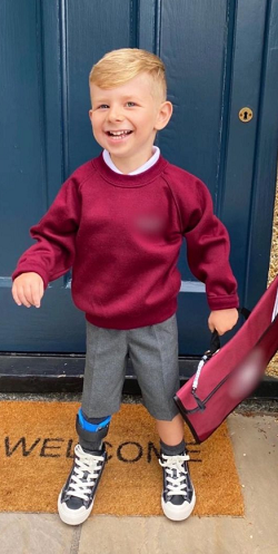 Arthur standing in his school uniform