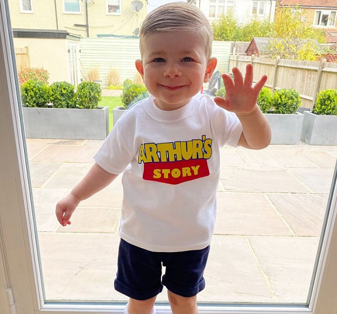 Arthur smiling wearing an Arthur's Story t-shirt