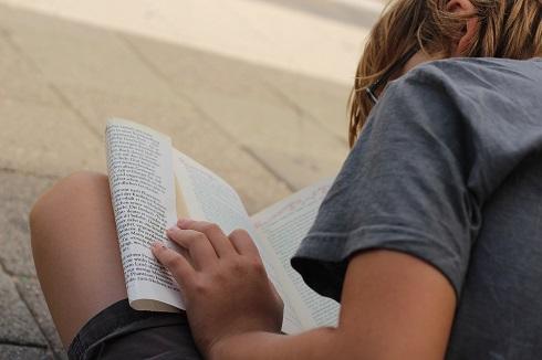 boy sat reading a book