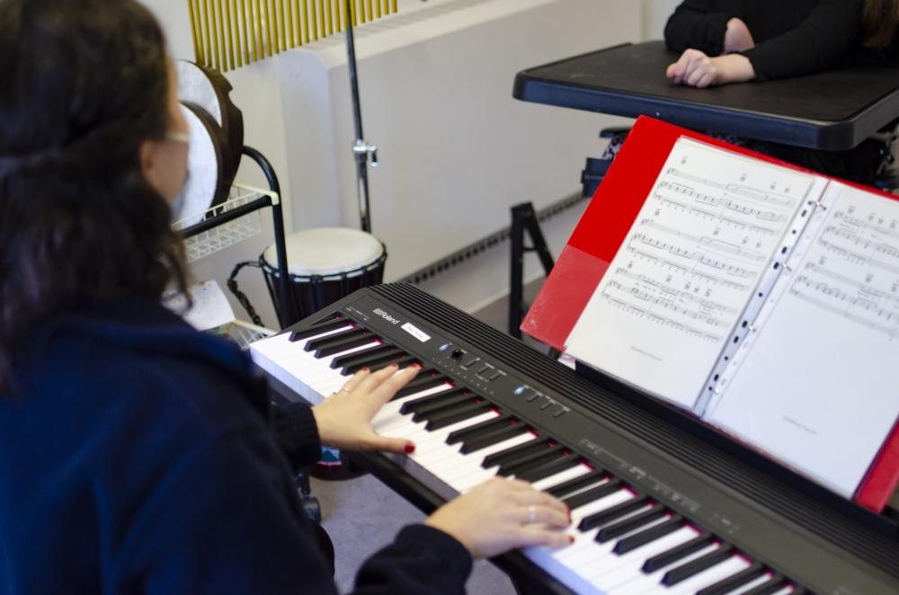 Music therapist playing a keyboard