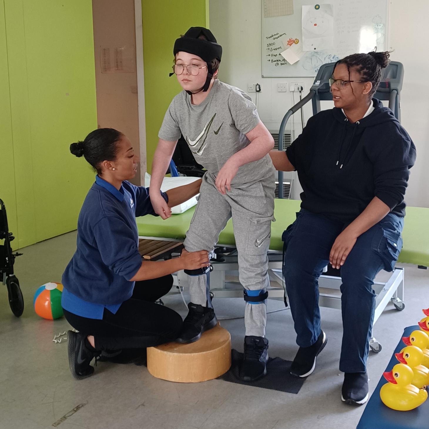 Riley standing in physiotherapy session