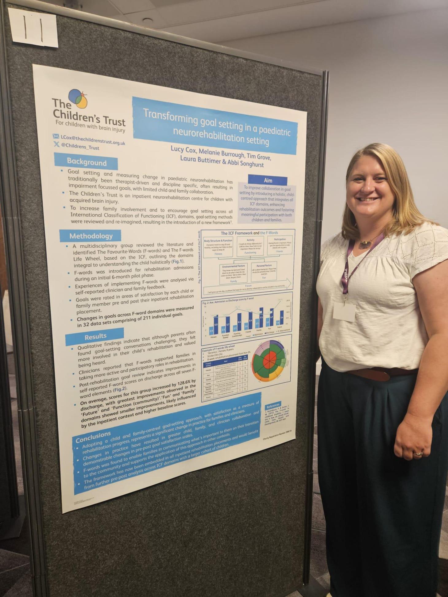 Staff member with conference poster