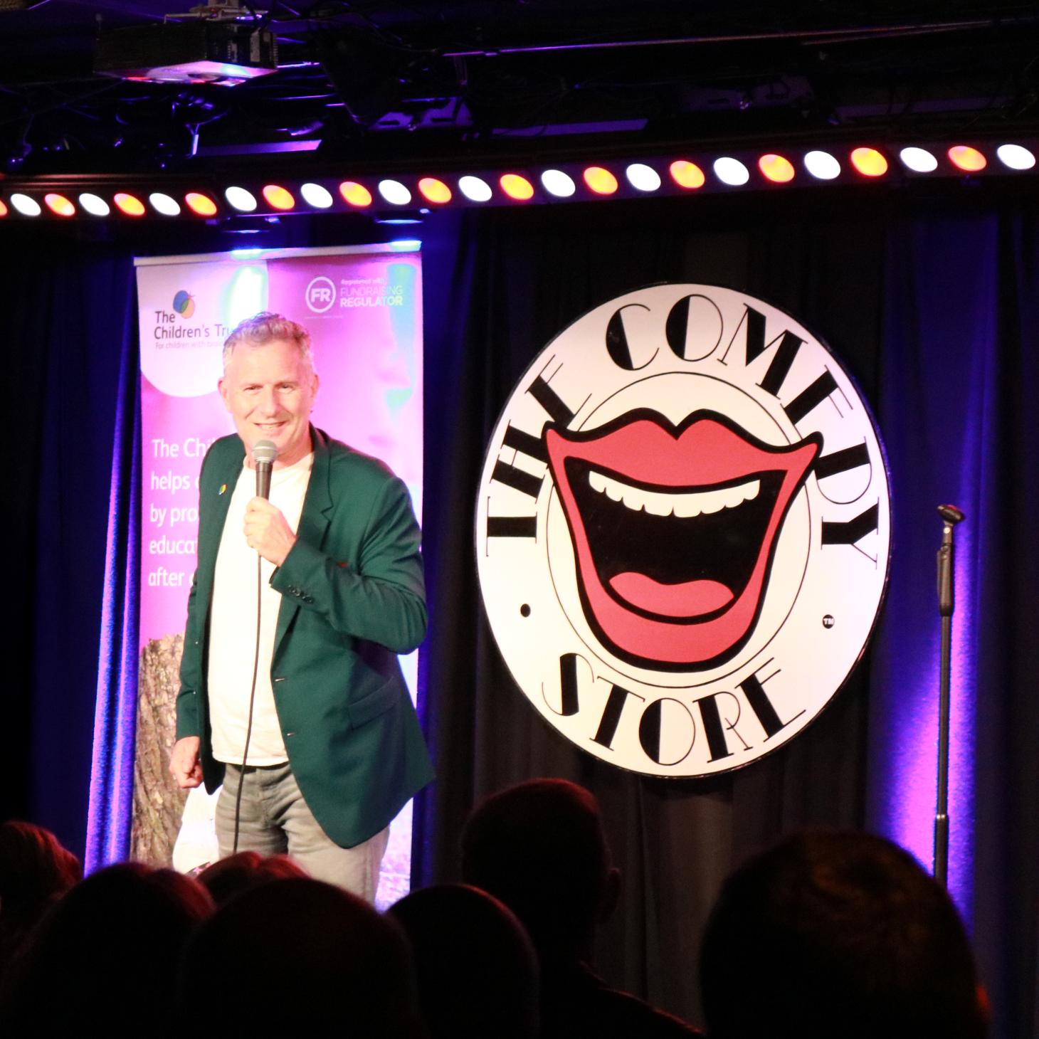 Adam Hills performing at comedy night 2025
