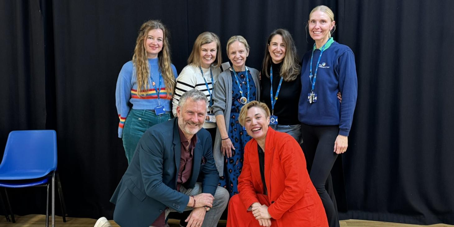 Staff, Adam Hills and Bec Hill smiling at the camera 