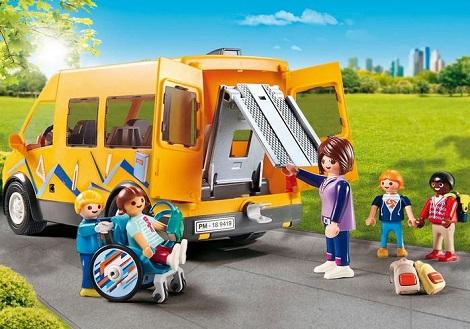 playmobil figures stand around a yellow van
