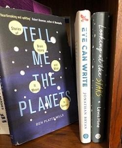 books on a bookshelf, with one titled 'tell me the planets'