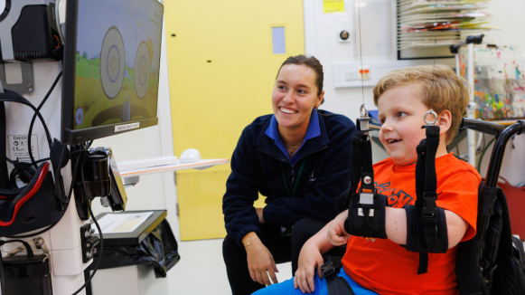 Ben at DIEGO machine with therapist.