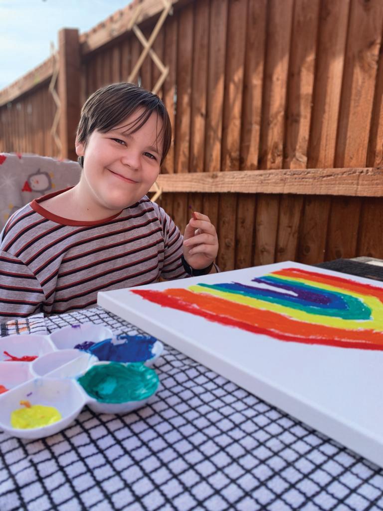 Joey painting rainbows in lockdown