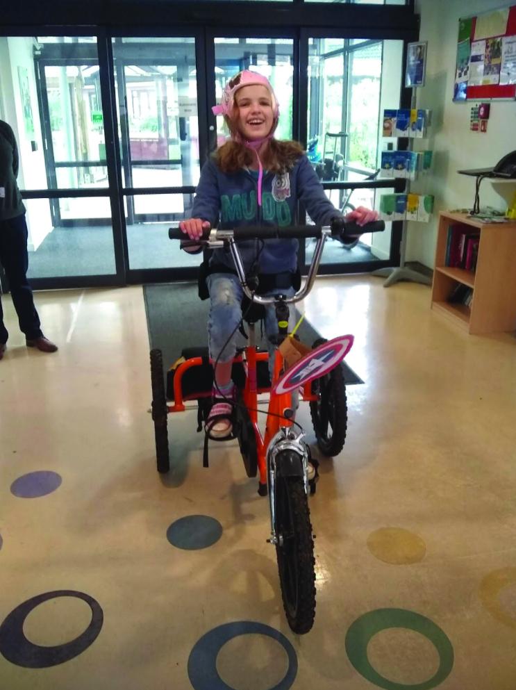 Mia on The Children's Trust tricycle