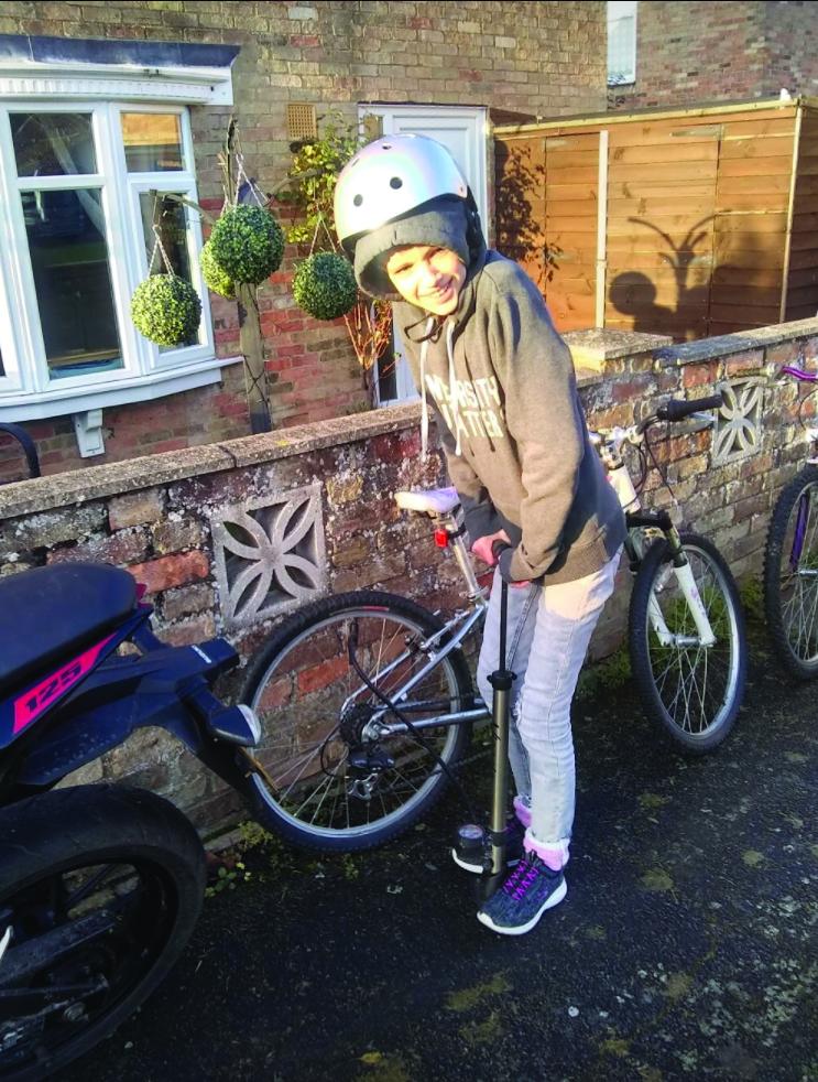 Mia back on her bike at home