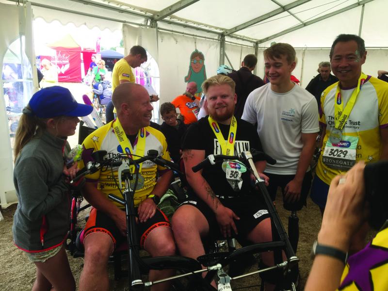 Ryan with his dad and Dalton at the Superhero Tri event