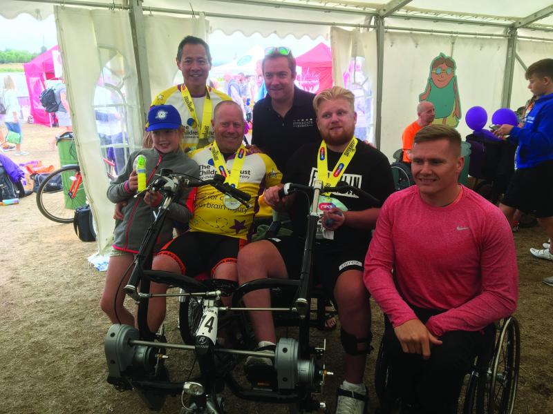 Ryan and his dad at Superhero Tri event with David Weir