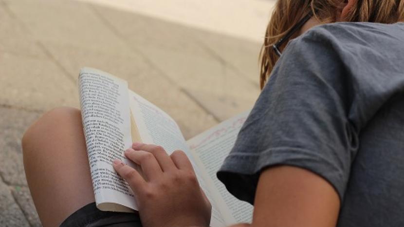 boy sat reading a book