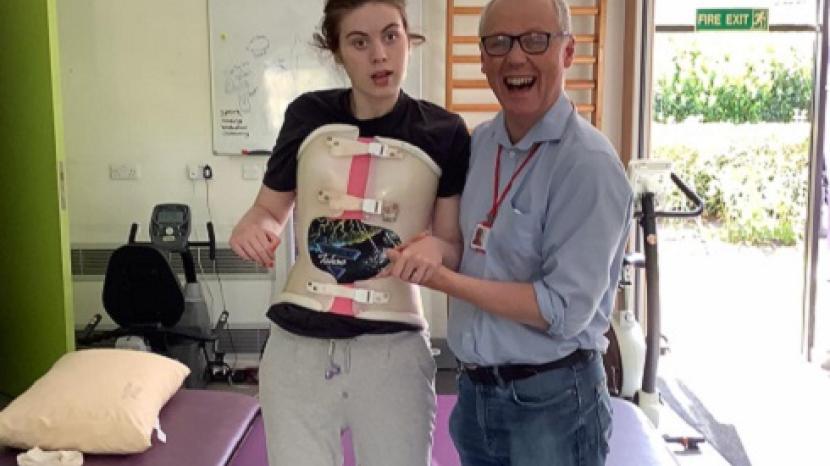 Floss standing next to her dad Robin at The Children's Trust
