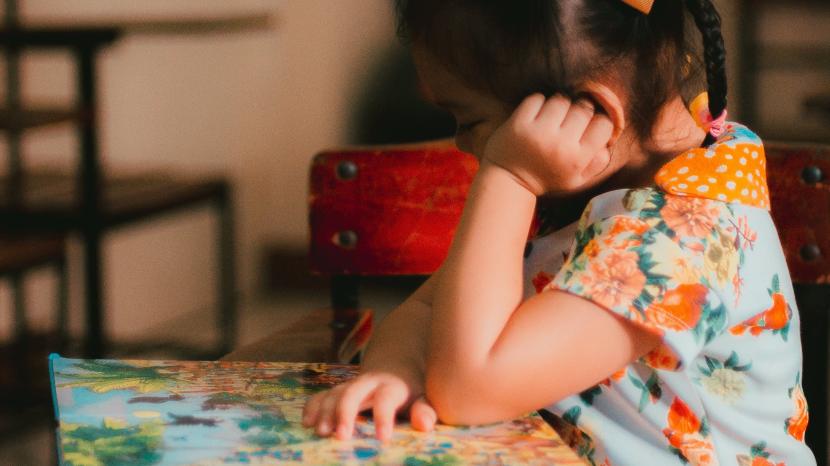 Girl in class quietly reading