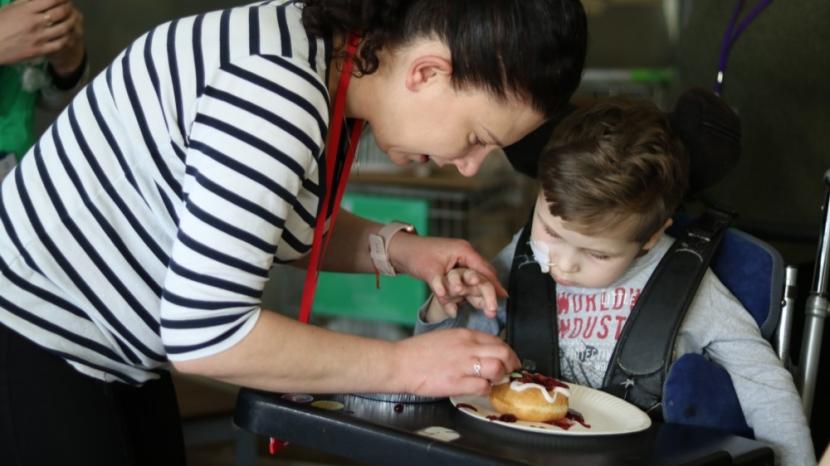 Gabriel decorating doughnuts for National Doughnut Week
