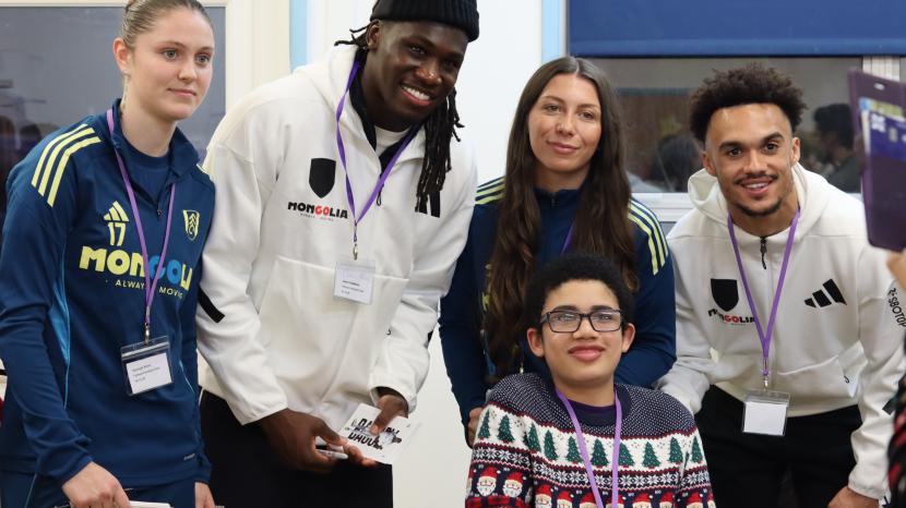 Child smiling with Fulham players