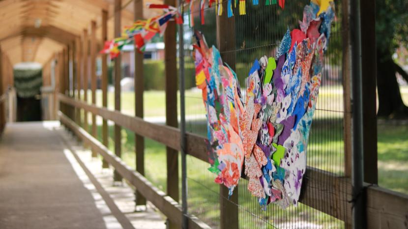 butterfly wings art with flags in a walkway